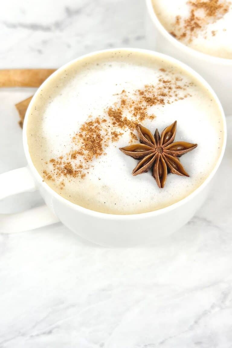 a dirty chai latte with tea bags topped with ground cinnamon